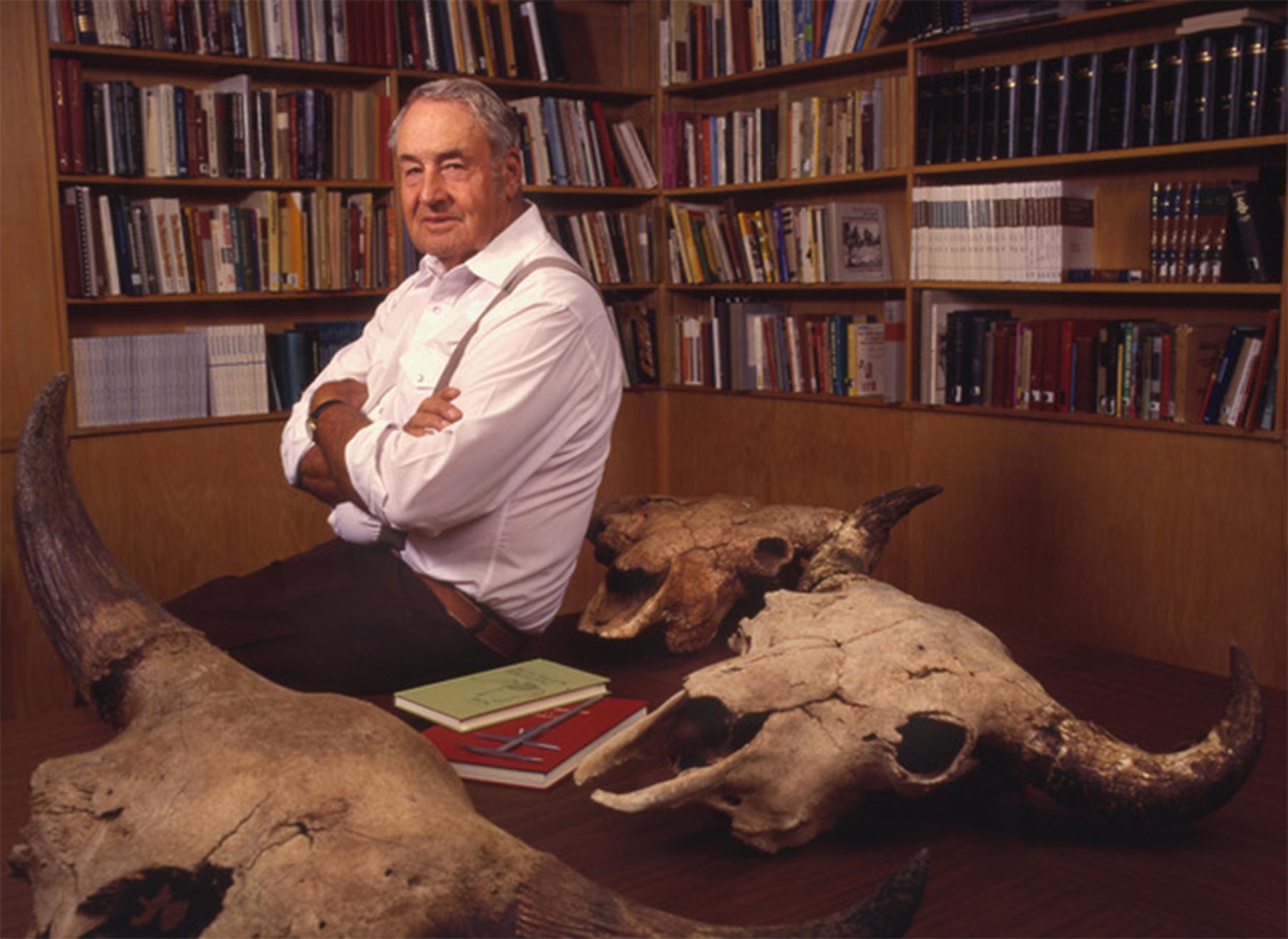 George Frison in his office with ancient bison skulls, late in his career. He was elected to the National Academy of Sciences in 1997. Ted Brummond, UW photo service.