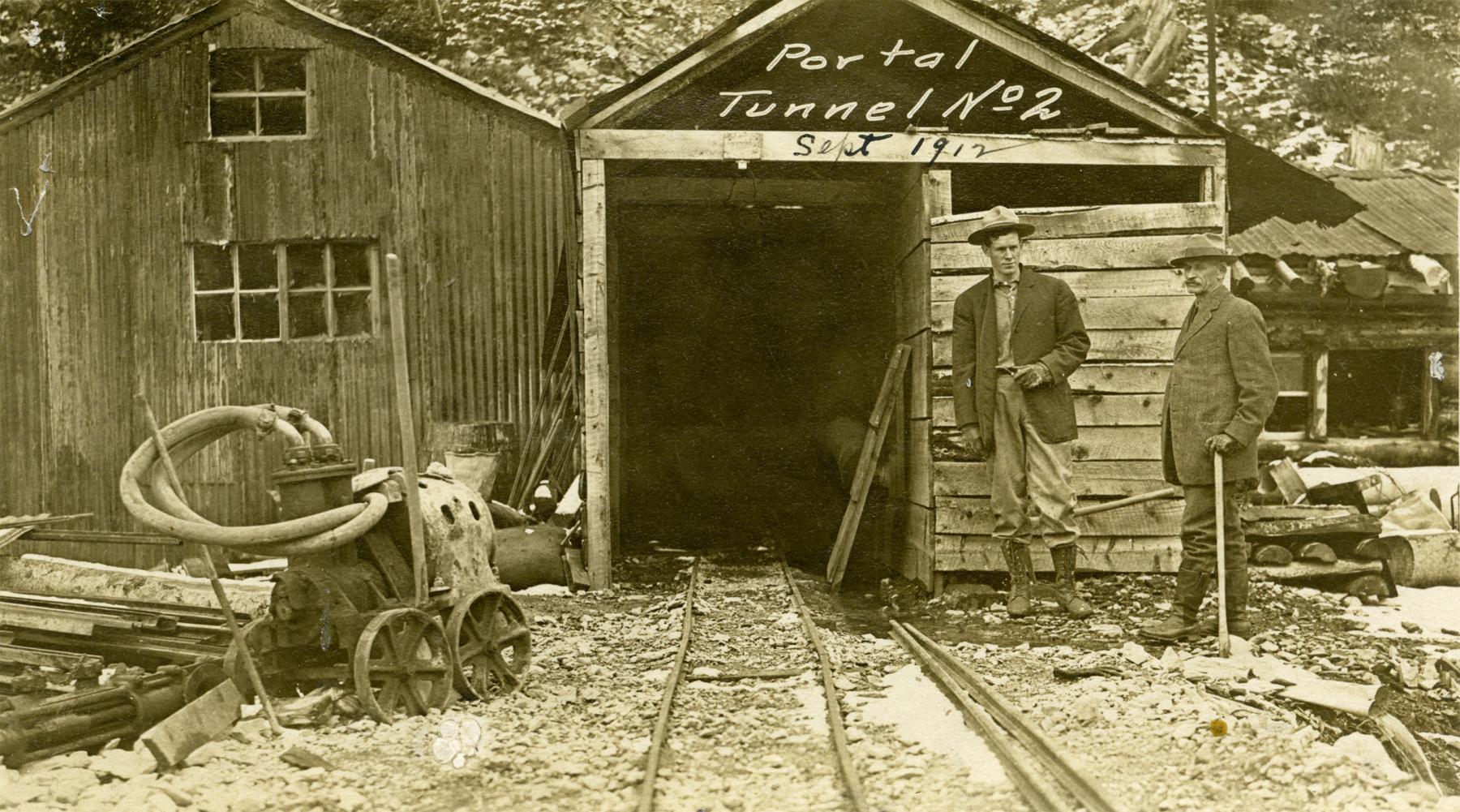 The Winona Gold & Copper Mining Company, a consortium of well-financed Colorado men, bought claims on Sulphur Creek high above Sunlight Basin in 1903. They excavated a pair of tunnels on the Greenhorn Claim following veins of copper ore. But they were 60 mountain miles from a railroad, and the operation never paid. Shown here, the mouth of Tunnel No. 2, 1912. Park County Archives.