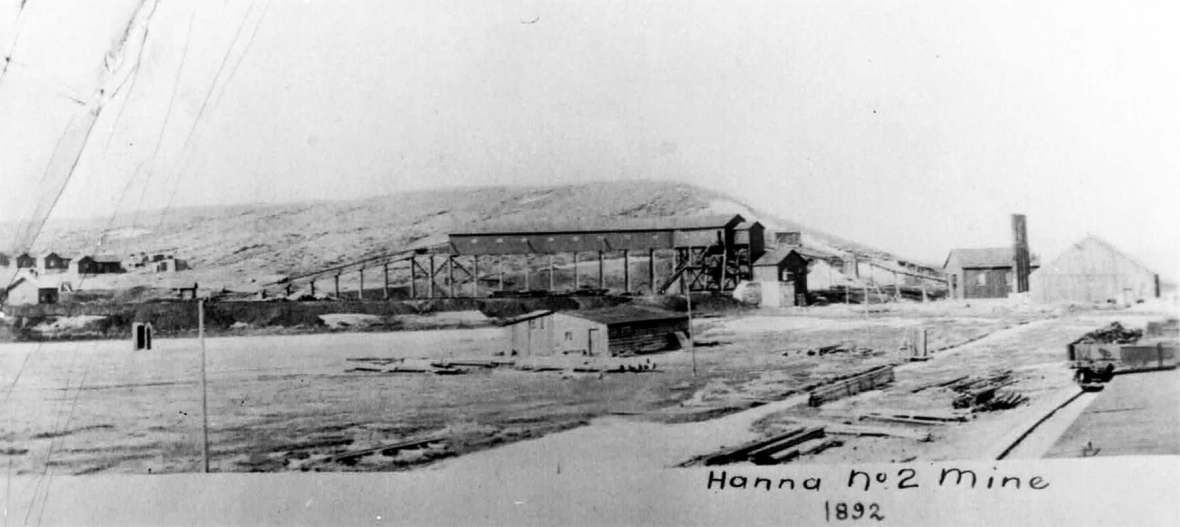 No photos of Dana have been identified. This 1892 image of the No. 2 mine in nearby Hanna, shows what area mining camps looked like. A coal tipple stands in the center of the photo with company housing visible in the distance at left. Sweetwater County Historical Museum. No photos of Dana have been identified. This 1892 image of the No. 2 mine in nearby Hanna, shows what area mining camps looked like. A coal tipple stands in the center of the photo with company housing visible in the distance at left. Sweetwater County Historical Museum.