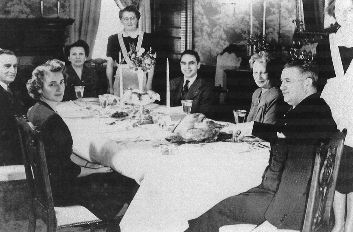 Thanksgiving dinner at the governor’s residence, date unknown, Cheyenne. L to r: U.S. Senator Joseph O’Mahoney; Elise Hunt; Nathelle Hunt; Johanna Scribner (residence cook); Lester “Buddy” Hunt, Jr.; Maude Higby (Nathelle’s mother) and Gov. Hunt. Courtesy Buddy Hunt. Thanksgiving dinner at the governor’s residence, date unknown, Cheyenne. L to r: U.S. Senator Joseph O’Mahoney; Elise Hunt; Nathelle Hunt; Johanna Scribner (residence cook); Lester “Buddy” Hunt, Jr.; Maude Higby (Nathelle’s mother) and Gov. Hunt. Courtesy Buddy Hunt.
