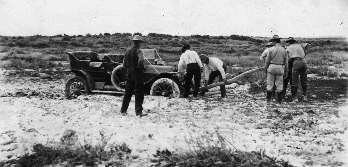 Seven men work to move a car out of the mud on the Lincoln Highway north of Laramie, Wyo., about 1915. In the early years of its existence, the highway was mostly an idea. Laramie Plains Museum. Seven men work to move a car out of the mud on the Lincoln Highway north of Laramie, Wyo., about 1915. In the early years of its existence, the highway was mostly an idea. Laramie Plains Museum.
