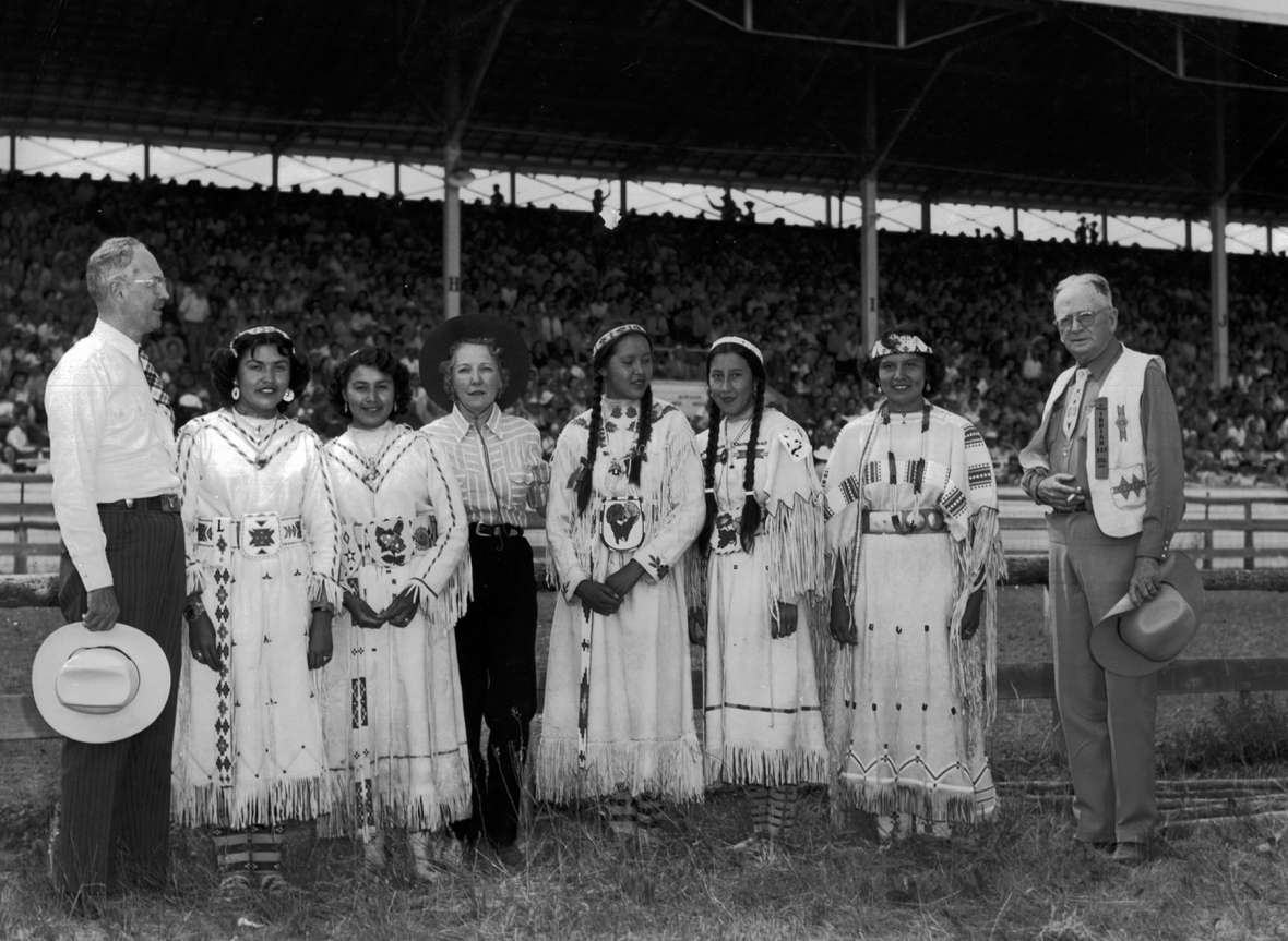 In 1953, the Freedoms Foundation of Valley Forge, Pa. awarded the Sheridan community a medal for ‘outstanding achievement’ in improving understanding between the American Indian and White races. Wyoming U.S. Representative William Henry Harrison and a committee of congressmen came to Sheridan in part to present the award at the first All-American Indian Day. Here, he stands at left with Lucy Yellowmule, Alta Driftwood, Mary Elizabeth Newton Harrison, Regina Spotted Horse, Joy Old Crow, Delores Little Coyote and Sheridan newspaperman and AAID founder Howard Sinclair. AAUW collection, SCFPL. In 1953, the Freedoms Foundation of Valley Forge, Pa. awarded the Sheridan community a medal for ‘outstanding achievement’ in improving understanding between the American Indian and White races. Wyoming U.S. Representative William Henry Harrison and a committee of congressmen came to Sheridan in part to present the award at the first All-American Indian Day. Here, he stands at left with Lucy Yellowmule, Alta Driftwood, Mary Elizabeth Newton Harrison, Regina Spotted Horse, Joy Old Crow, Delores Little Coyote and Sheridan newspaperman and AAID founder Howard Sinclair. AAUW collection, SCFPL.