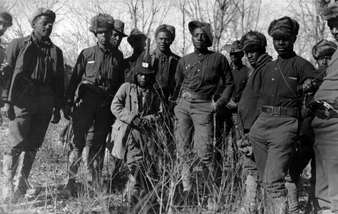 Units of the Tenth Cavalry, stationed at Fort Robinson in Nebraska, were the first sent by the Army after the Utes. Shown here, some of the buffalo soldiers in camp on Powder River, with a Ute friend. T.W. Tolman photo, Northwest Museum of Arts and Culture. Units of the Tenth Cavalry, stationed at Fort Robinson in Nebraska, were the first sent by the Army after the Utes. Shown here, some of the buffalo soldiers in camp on Powder River, with a Ute friend. T.W. Tolman photo, Northwest Museum of Arts and Culture.