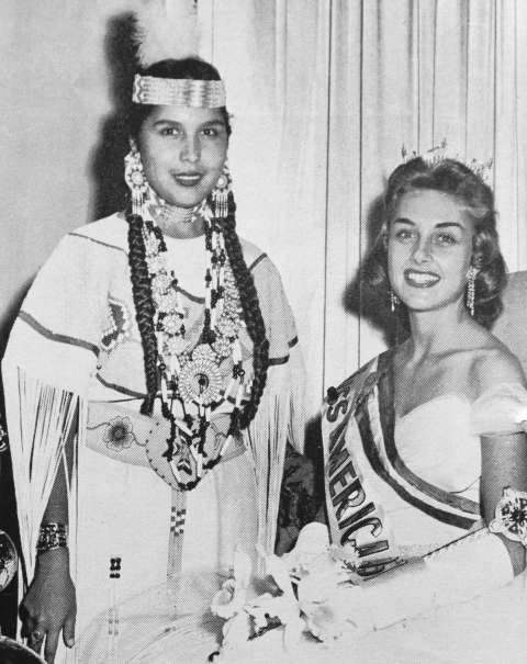 Miss Indian America 1956, Sandra May Gover, and Miss America 1957, Marian Ann McKnight, at an appearance in Atlantic City, New Jersey. The widely popular Miss America Pageant served as a model for the Miss Indian America competition. As a guest of honor in Atlantic City, Gover was expected to appear before the press and on television, attend social functions, and address the convention attendees. MIA booklet collection, THE Wyoming Room, SCFPL. Miss Indian America 1956, Sandra May Gover, and Miss America 1957, Marian Ann McKnight, at an appearance in Atlantic City, New Jersey. The widely popular Miss America Pageant served as a model for the Miss Indian America competition. As a guest of honor in Atlantic City, Gover was expected to appear before the press and on television, attend social functions, and address the convention attendees. MIA booklet collection, THE Wyoming Room, SCFPL.